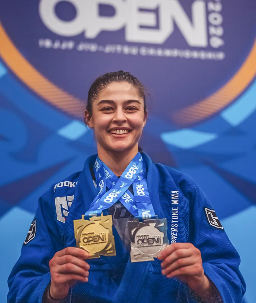 Rana Muratoglu holding gold and silver medals at an IBJJF Open
