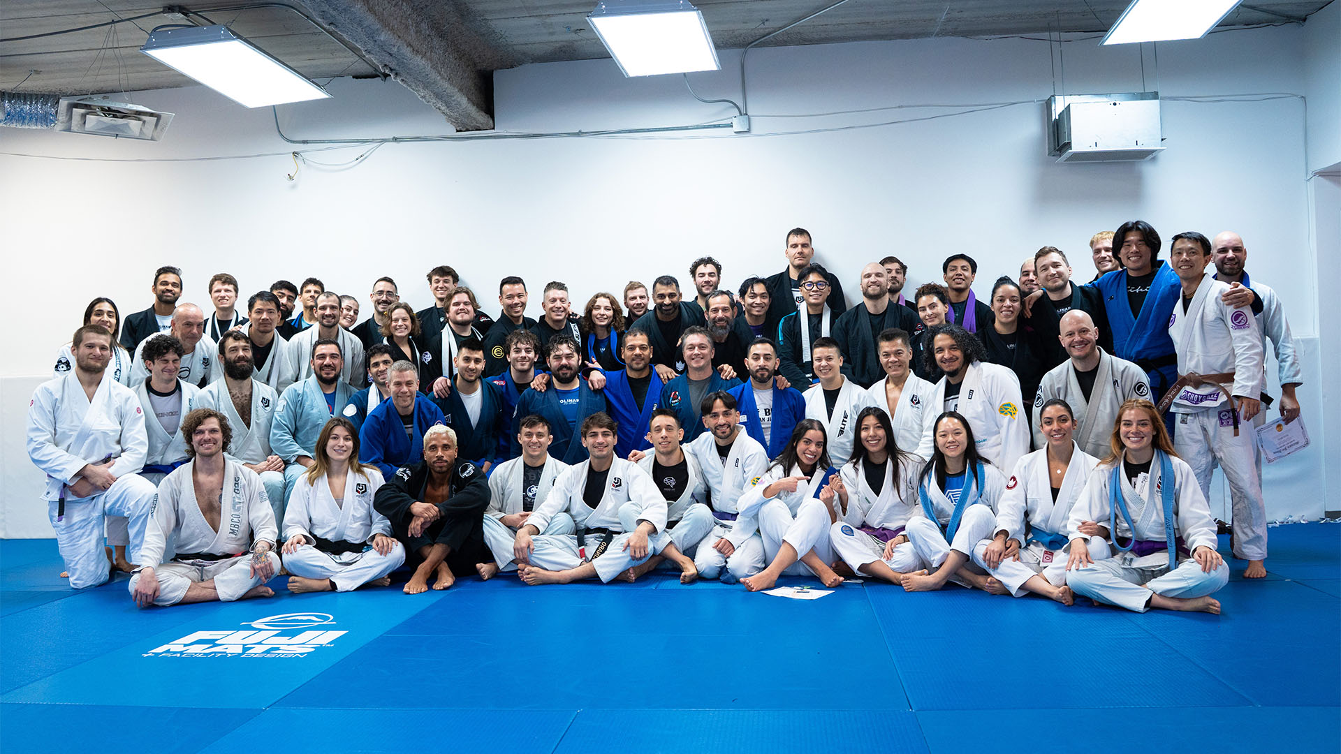 A big group of Molinaro Jiu-Jitsu members and coaches posing together at the academy